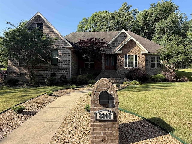 2207 Byrnewood, Jonesboro, AR 72404 - view of front of property featuring a front yard, brick siding, and french doors