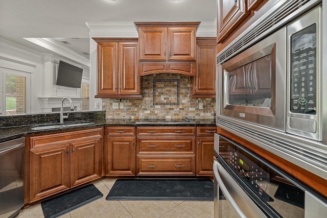 2207 Byrnewood, Jonesboro, AR 72404 - kitchen featuring a sink, appliances with stainless steel finishes, ornamental molding, decorative backsplash, and dark stone counters