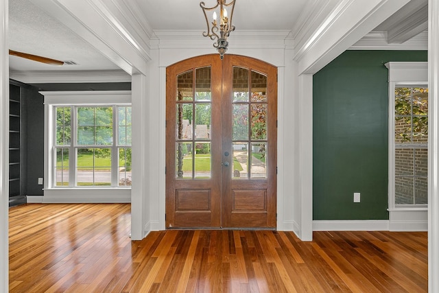 2207 Byrnewood, Jonesboro, AR 72404 - foyer entrance featuring french doors, hardwood / wood-style floors, ornamental molding, and baseboards