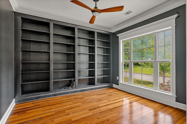 2207 Byrnewood, Jonesboro, AR 72404 - spare room featuring baseboards, wood-type flooring, ceiling fan, and crown molding