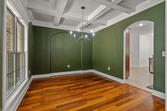 2207 Byrnewood, Jonesboro, AR 72404 - spare room featuring arched walkways, hardwood / wood-style flooring, coffered ceiling, crown molding, and beamed ceiling