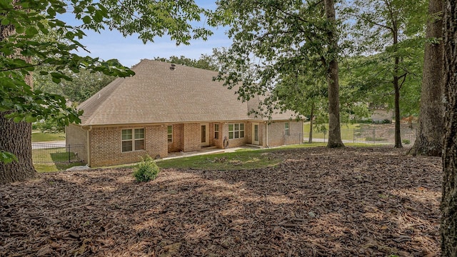 2207 Byrnewood, Jonesboro, AR 72404 - rear view of house featuring brick siding, roof with shingles, and a patio area