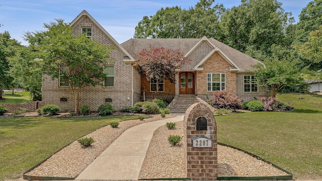 2207 Byrnewood, Jonesboro, AR 72404 - view of front facade featuring brick siding, a front yard, and a shingled roof