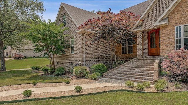 2207 Byrnewood, Jonesboro, AR 72404 - view of front of house with brick siding, a front yard, and a shingled roof