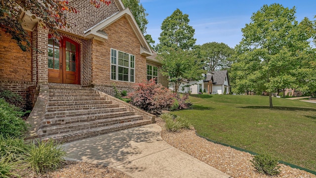 2207 Byrnewood, Jonesboro, AR 72404 - property entrance with brick siding, a lawn, and french doors