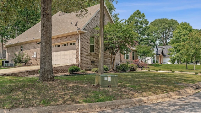 2207 Byrnewood, Jonesboro, AR 72404 - view of front of house featuring brick siding, a garage, cooling unit, and a front yard
