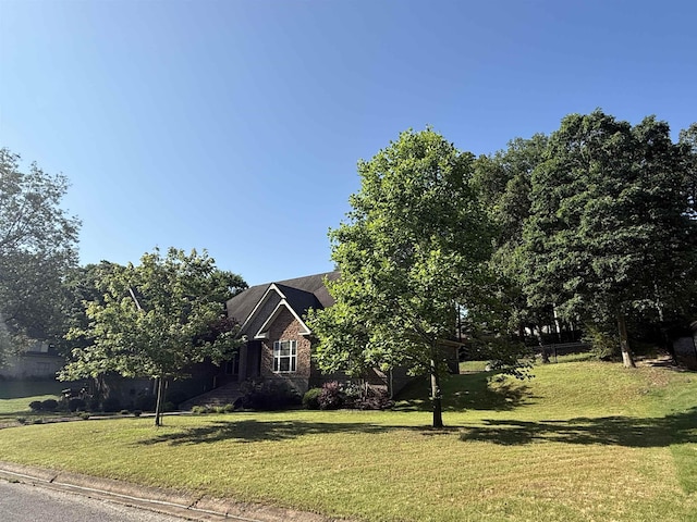 2207 Byrnewood, Jonesboro, AR 72404 - view of property hidden behind natural elements with a front lawn and brick siding
