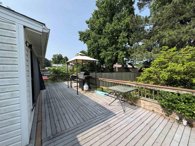821 S 12th Ave, Piggott, AR 72454 - wooden deck with a gazebo and area for grilling