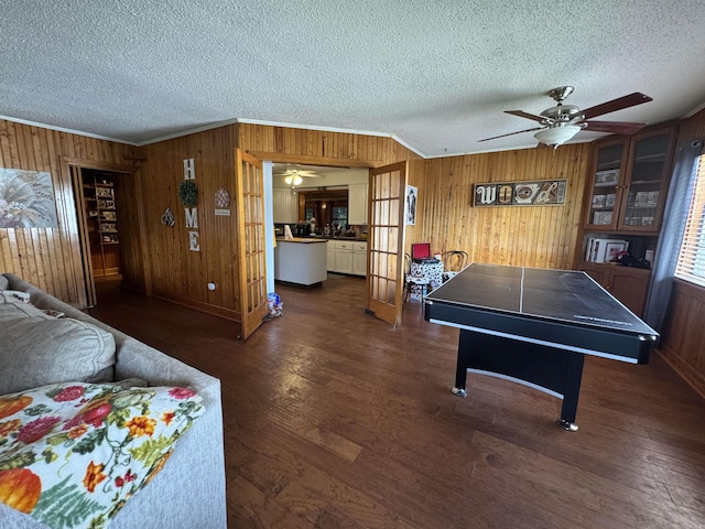 821 S 12th Ave, Piggott, AR 72454 - game room featuring wooden walls, a ceiling fan, ornamental molding, a textured ceiling, and wood finished floors