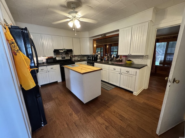 821 S 12th Ave, Piggott, AR 72454 - kitchen featuring wooden counters, appliances with stainless steel finishes, and white cabinets