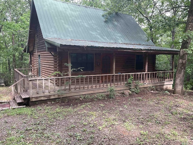 1602 Lake Clf, Higden, AR 72067 - view of front facade with covered porch, metal roof, and log exterior
