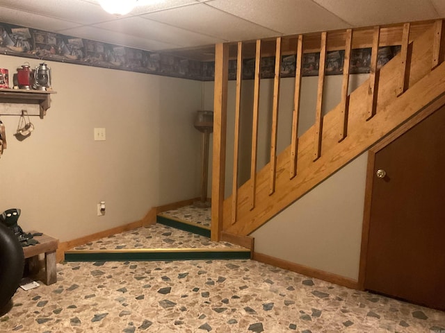 1602 Lake Clf, Higden, AR 72067 - finished below grade area featuring baseboards, a drop ceiling, stone finish flooring, and stairs