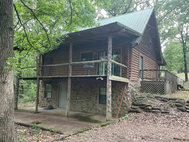 1602 Lake Clf, Higden, AR 72067 - rear view of house with a patio area, stone siding, a deck, and metal roof
