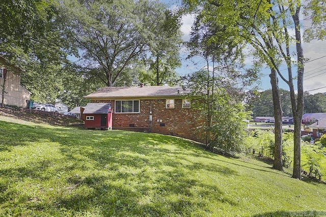 5 Brookridge Dr, Little Rock, AR 72205 - rear view of property featuring brick siding, a lawn, and an outbuilding