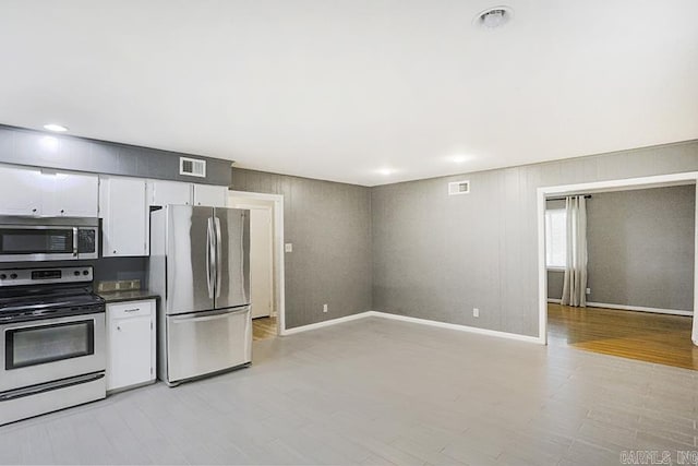 5 Brookridge Dr, Little Rock, AR 72205 - kitchen with stainless steel appliances, light wood-type flooring, white cabinetry, and baseboards