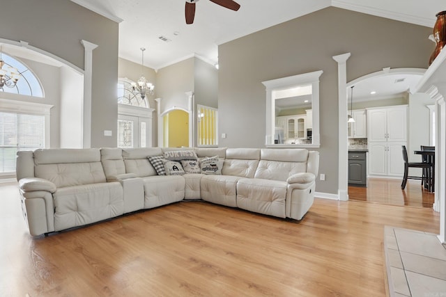 5017 Calico Creek Cv, North Little Rock, AR 72116 - living room featuring ceiling fan, crown molding, arched walkways, light wood finished floors, and a chandelier