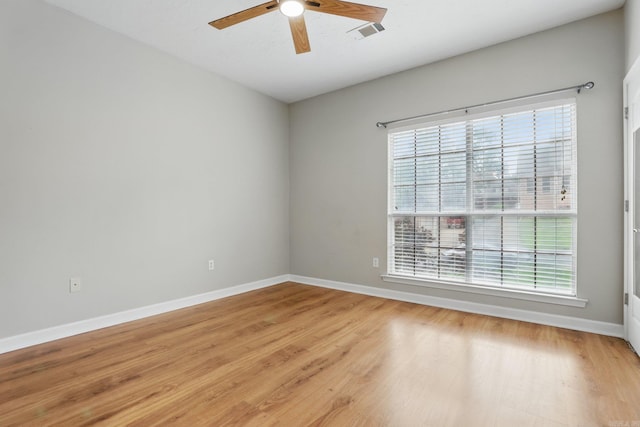 5017 Calico Creek Cv, North Little Rock, AR 72116 - empty room featuring healthy amount of natural light, a ceiling fan, light wood-type flooring, and baseboards