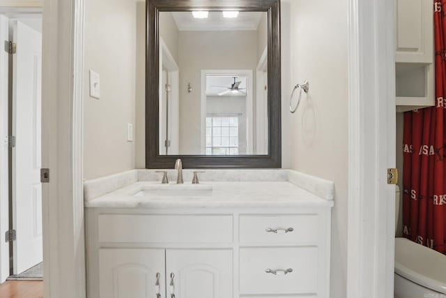5017 Calico Creek Cv, North Little Rock, AR 72116 - bathroom featuring vanity, ceiling fan, and toilet