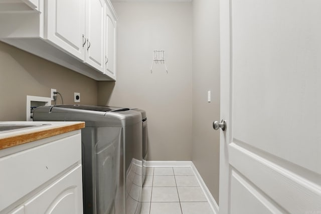 5017 Calico Creek Cv, North Little Rock, AR 72116 - washroom with cabinet space, independent washer and dryer, baseboards, and light tile patterned floors