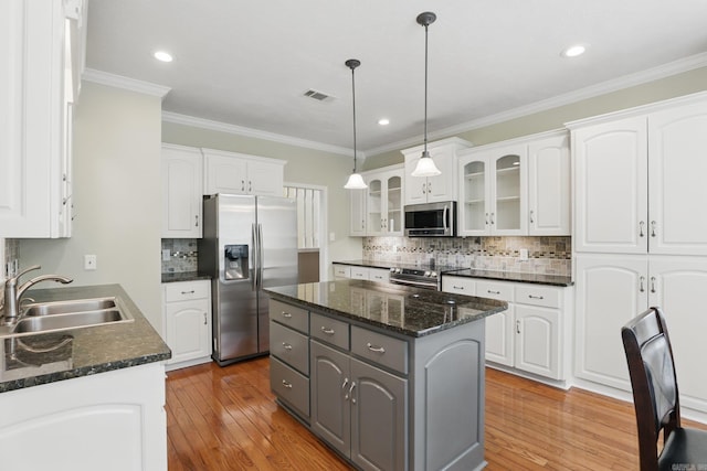 5017 Calico Creek Cv, North Little Rock, AR 72116 - kitchen featuring appliances with stainless steel finishes, a sink, gray cabinetry, white cabinets, and ornamental molding