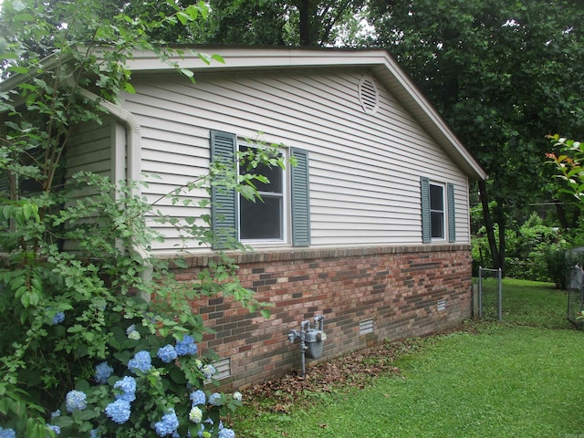 905 Merritt St, Searcy, AR 72143 - view of home's exterior featuring a lawn and brick siding