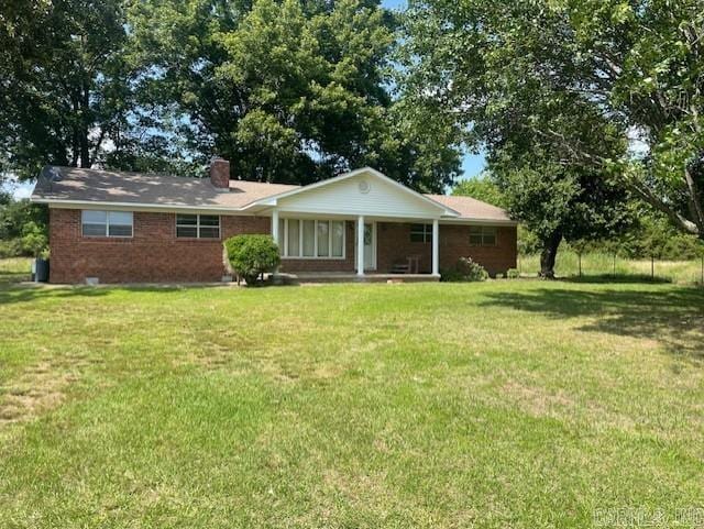 1995 Rosebud Rd, Quitman, AR 72131 - view of front of property with covered porch, a front lawn, a chimney, and brick siding