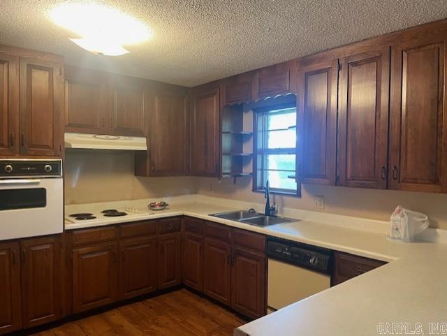 1995 Rosebud Rd, Quitman, AR 72131 - kitchen with white appliances, a sink, under cabinet range hood, a textured ceiling, and light countertops