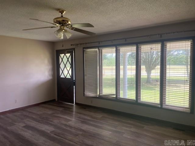 1995 Rosebud Rd, Quitman, AR 72131 - foyer with a textured ceiling, dark wood-type flooring, ceiling fan, and baseboards