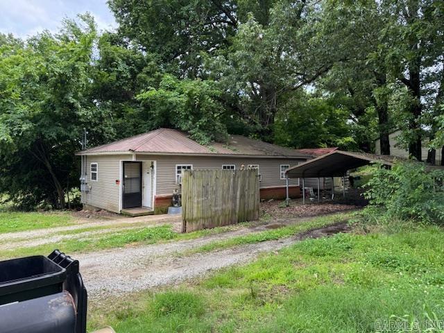 1301A Imboden St, Pocahontas, AR 72455 - view of front of house featuring a detached carport, driveway, and metal roof