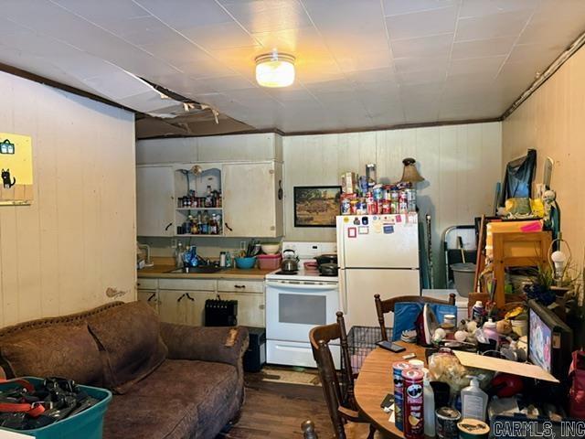 1301A Imboden St, Pocahontas, AR 72455 - kitchen featuring white appliances, dark wood-style floors, a sink, and wood walls