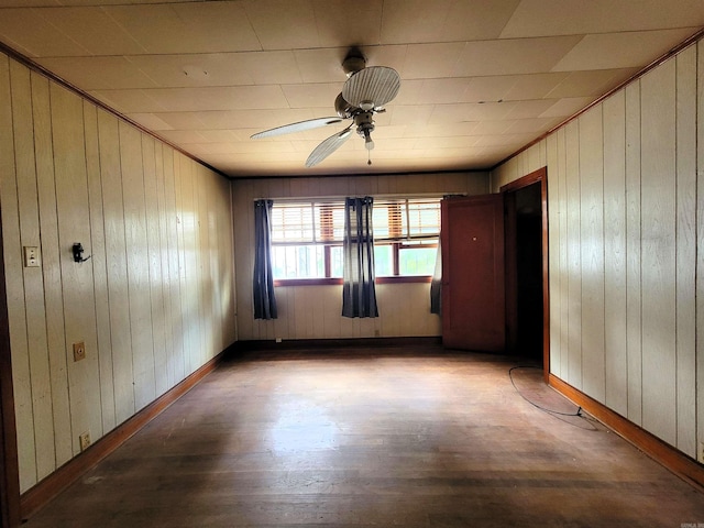 1930 S Olive, Pine Bluff, AR 71603 - empty room with wooden walls, ceiling fan, and wood finished floors
