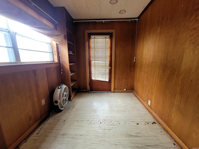 1930 S Olive, Pine Bluff, AR 71603 - unfurnished room featuring wood walls, healthy amount of natural light, and light floors