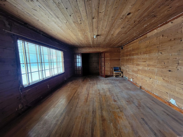 1930 S Olive, Pine Bluff, AR 71603 - unfurnished living room featuring wood ceiling, wood walls, and wood-type flooring