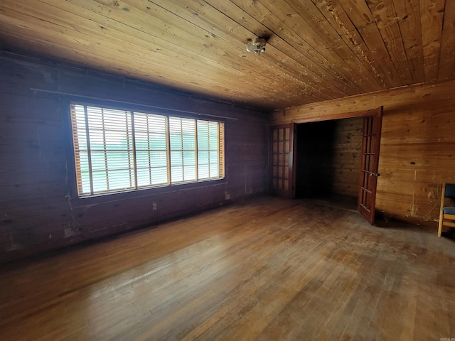 1930 S Olive, Pine Bluff, AR 71603 - spare room with wooden ceiling, hardwood / wood-style flooring, and wood walls
