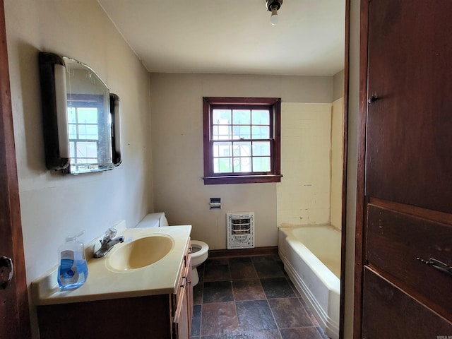 1930 S Olive, Pine Bluff, AR 71603 - full bathroom featuring heating unit, toilet, vanity, stone finish flooring, and baseboards
