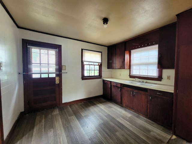 1930 S Olive, Pine Bluff, AR 71603 - kitchen featuring a sink, dark wood-type flooring, light countertops, baseboards, and dark brown cabinetry