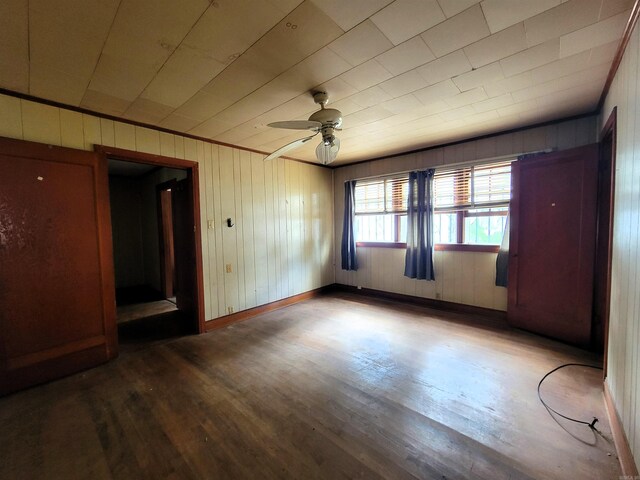 1930 S Olive, Pine Bluff, AR 71603 - spare room with wood finished floors, a ceiling fan, wood walls, and baseboards