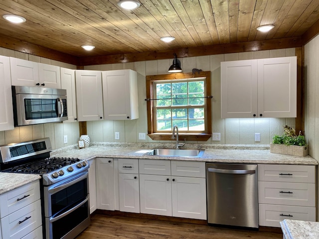 5867 County Road 4160, Ozark, AR 72949 - kitchen with appliances with stainless steel finishes, a sink, wood ceiling, white cabinetry, and dark wood-style flooring
