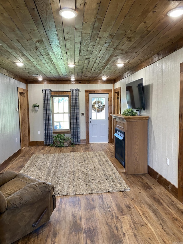 5867 County Road 4160, Ozark, AR 72949 - entrance foyer featuring wooden ceiling, wooden walls, baseboards, wood finished floors, and a fireplace