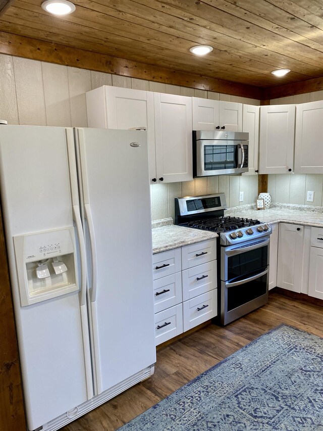 5867 County Road 4160, Ozark, AR 72949 - kitchen with stainless steel appliances, wooden ceiling, dark wood-style floors, white cabinets, and light stone counters