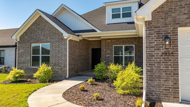 2333 Pleasant Cv, Conway, AR 72034 - property entrance with board and batten siding, brick siding, and a shingled roof