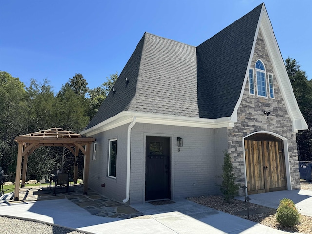 51 Yosemite Dr, Cherokee Village, AR 72529 - view of front of house with roof with shingles, a gazebo, a patio area, and brick siding