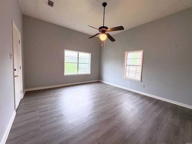 1621 Maple St, North Little Rock, AR 72114 - unfurnished room featuring healthy amount of natural light, dark wood-style flooring, a ceiling fan, and baseboards