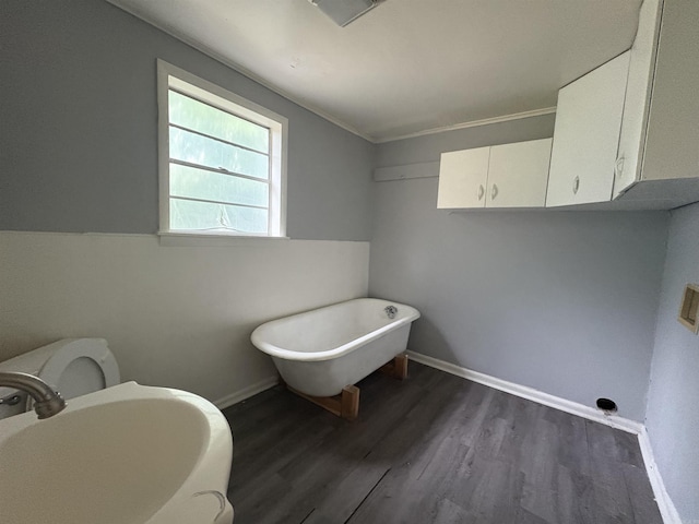 1621 Maple St, North Little Rock, AR 72114 - bathroom featuring a freestanding tub, a sink, wood finished floors, and baseboards