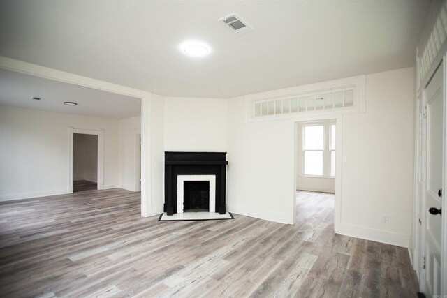 2715 S State St, Little Rock, AR 72206 - unfurnished living room with wood finished floors, a fireplace with flush hearth, and baseboards