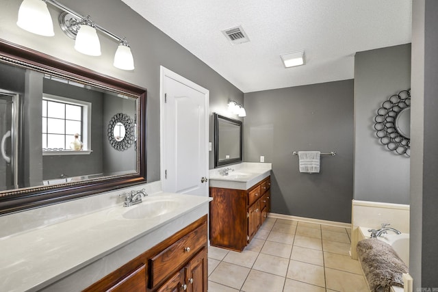 113 Deer View Cir, Hot Springs, AR 71913 - bathroom featuring two vanities, tile patterned flooring, a bath, baseboards, and a textured ceiling
