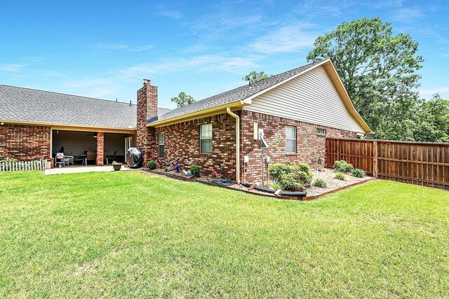 113 Deer View Cir, Hot Springs, AR 71913 - rear view of house with a chimney, a patio, brick siding, and roof with shingles