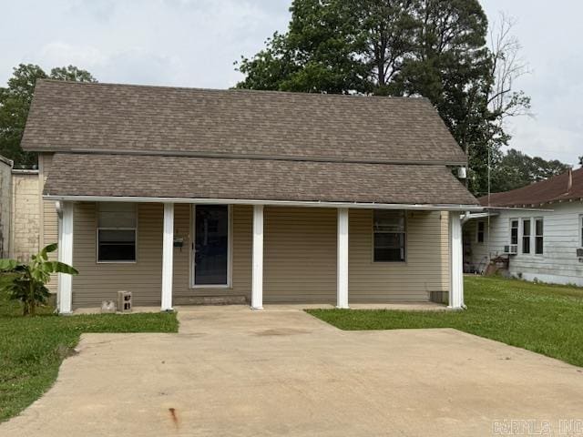217 SE 3rd, England, AR 72046 - bungalow-style home with a shingled roof and a front lawn