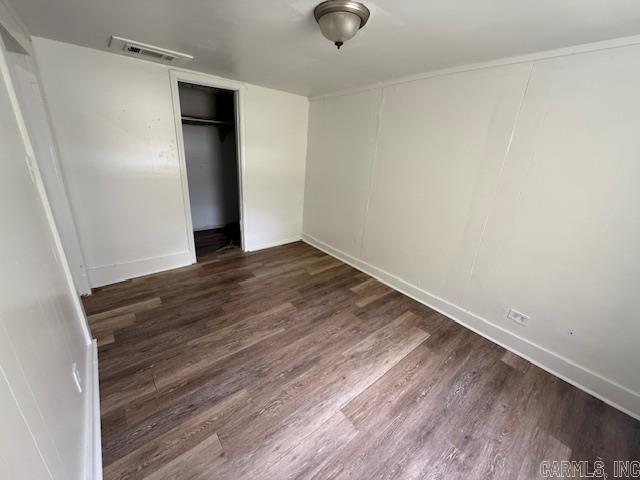 217 SE 3rd, England, AR 72046 - unfurnished bedroom with wood finished floors, baseboards, and a closet