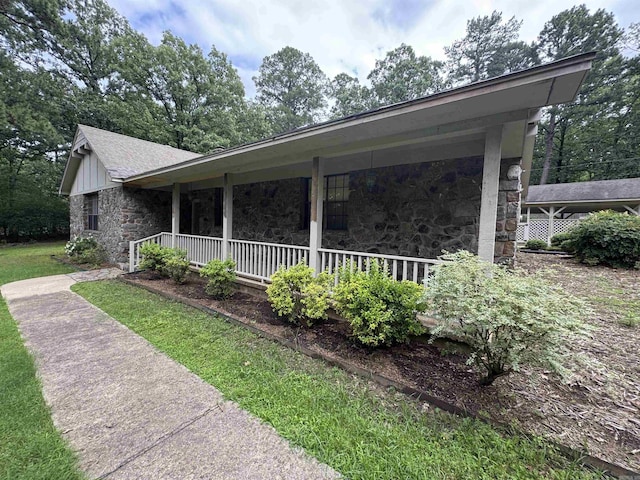 5901 Star Ln, Little Rock, AR 72223 - view of side of home with stone siding, covered porch, a shingled roof, and board and batten siding